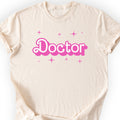 Doctor Pink Doll T-shirt — Retro Script — Natural
